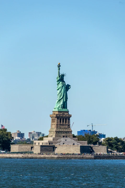 the statue of liberty stands on the water