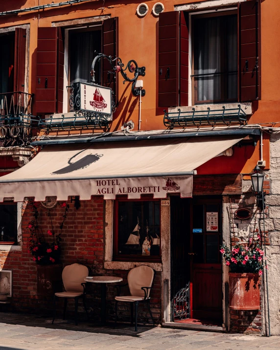 a couple of chairs are sitting outside a restaurant