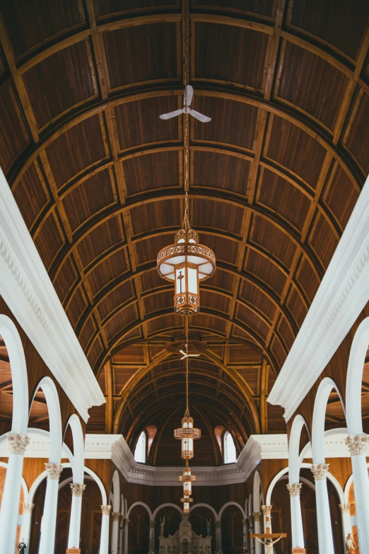 an image of a building that has a cross and chandelier hanging