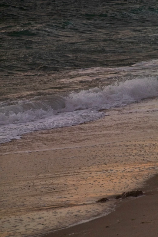 a person riding on a surfboard in the ocean