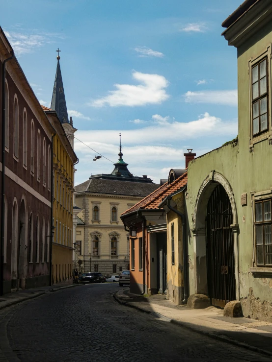 an empty street with a clock tower in the background