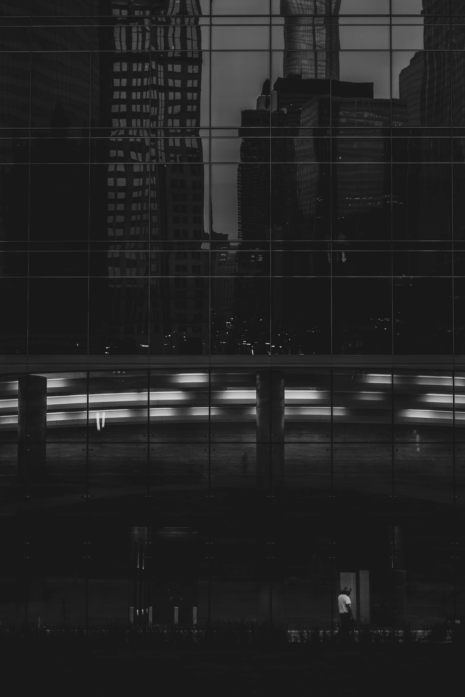 the lights on the city street are reflected in the windows