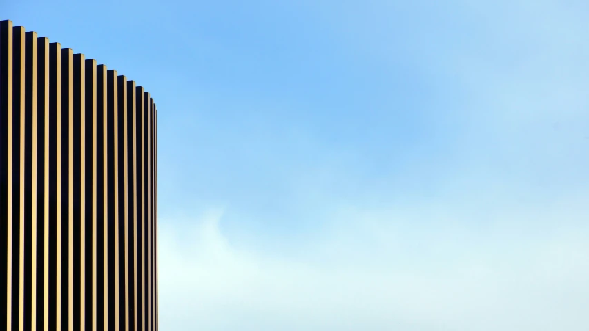 a clock on top of a building near the sky