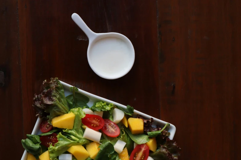 a salad sitting in a dish on top of a wooden table