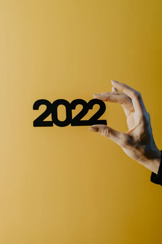 a person's hand and arm reaching into a paper cutout that says 2012