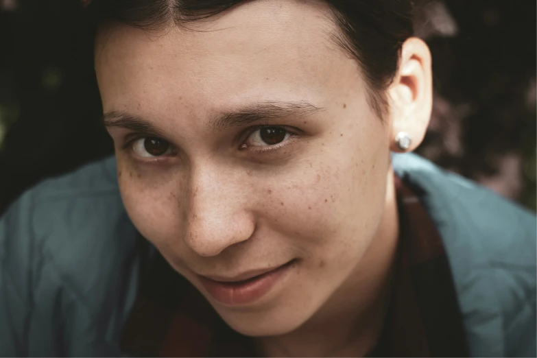 a close up of a person wearing an earring