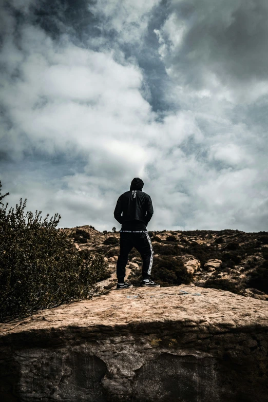 a person walking up a small hill on a cloudy day