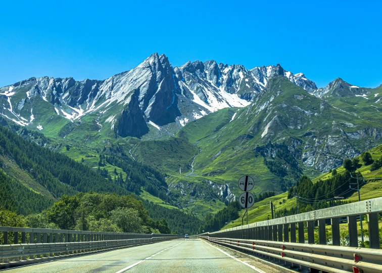 a road with mountains in the background and a sky background