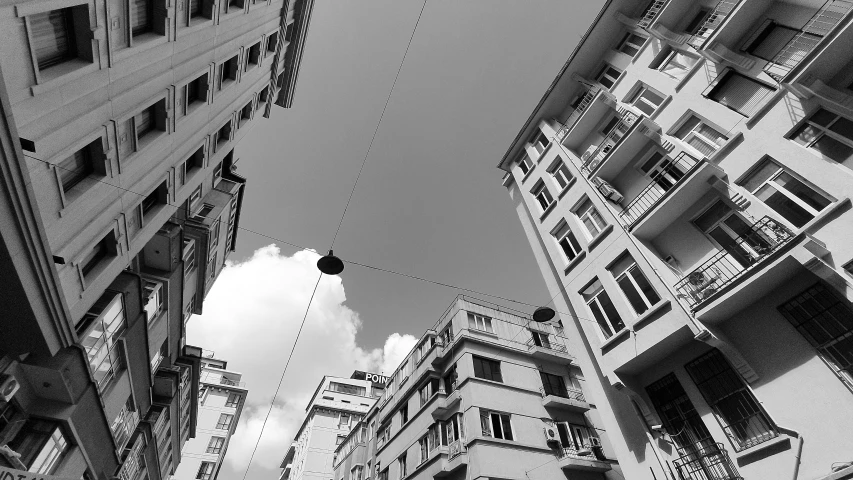 some large building and telephone wires are in a row