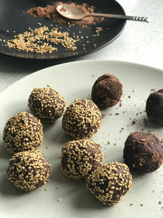 seven chocolate truffles are placed on a plate