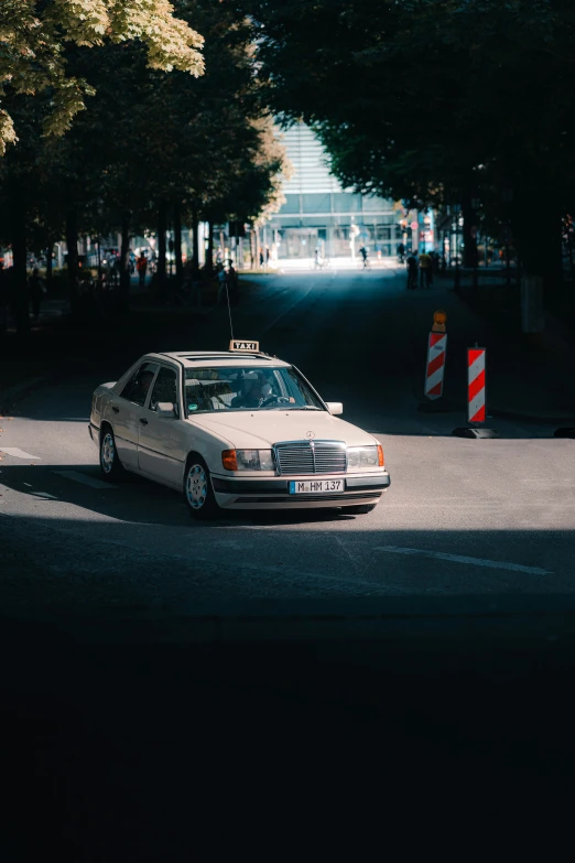 a car is traveling through the park with a street sign