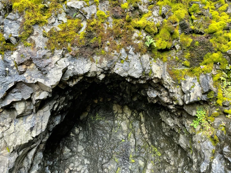 a large stone cave that is in a mountain