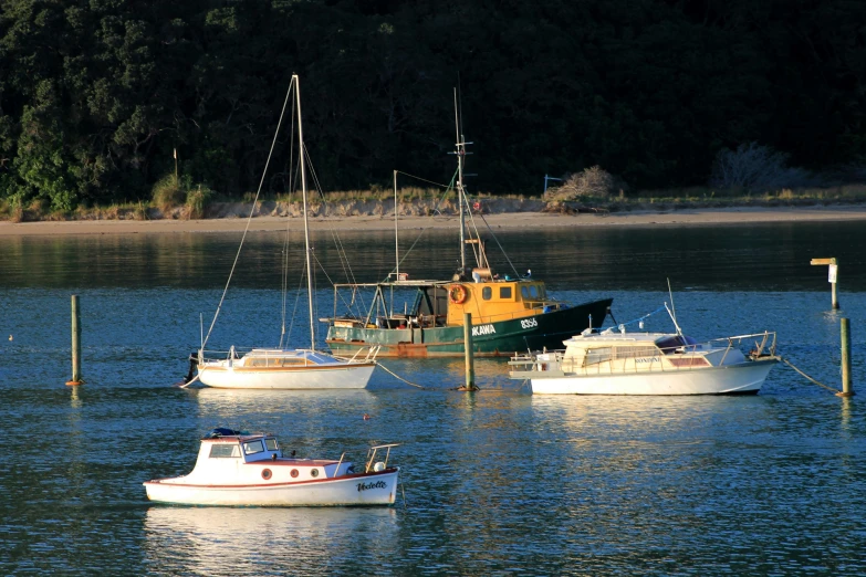 three boats in the water at a lake