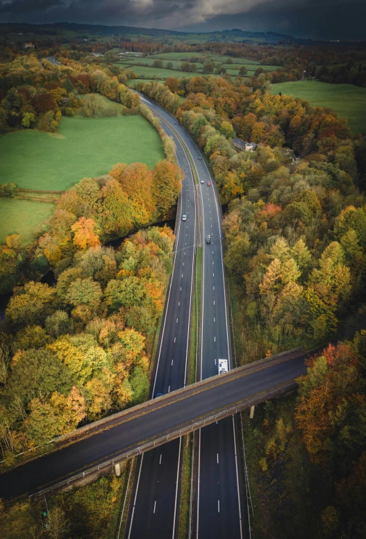 a long stretch of road with many lanes under a cloudy sky