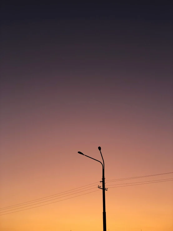 the setting sun over a city street with an antenna