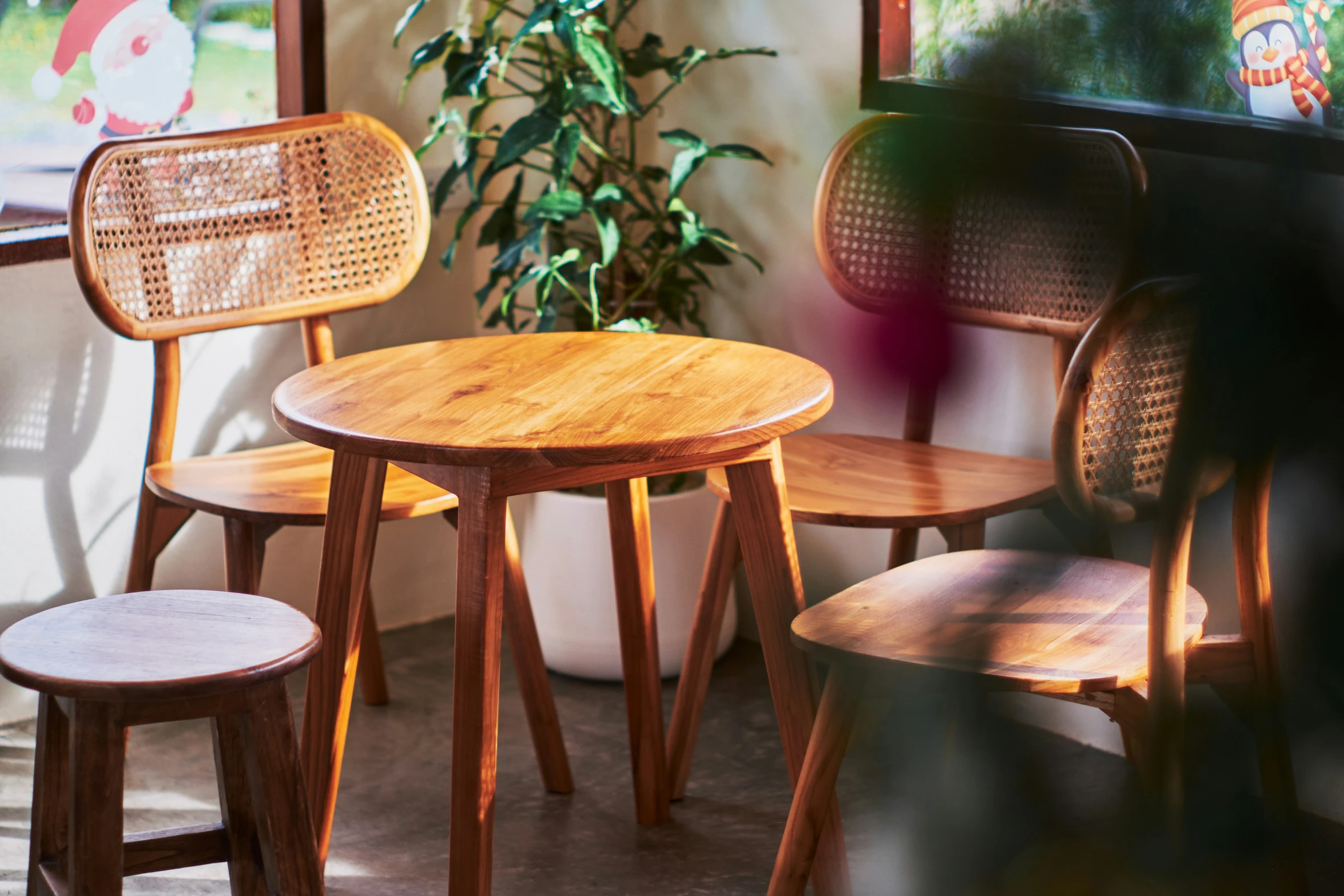 three wooden stools on top of a wood table in a room