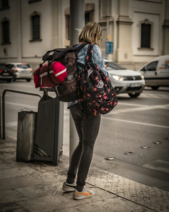 a woman on the street with her back pack and luggage