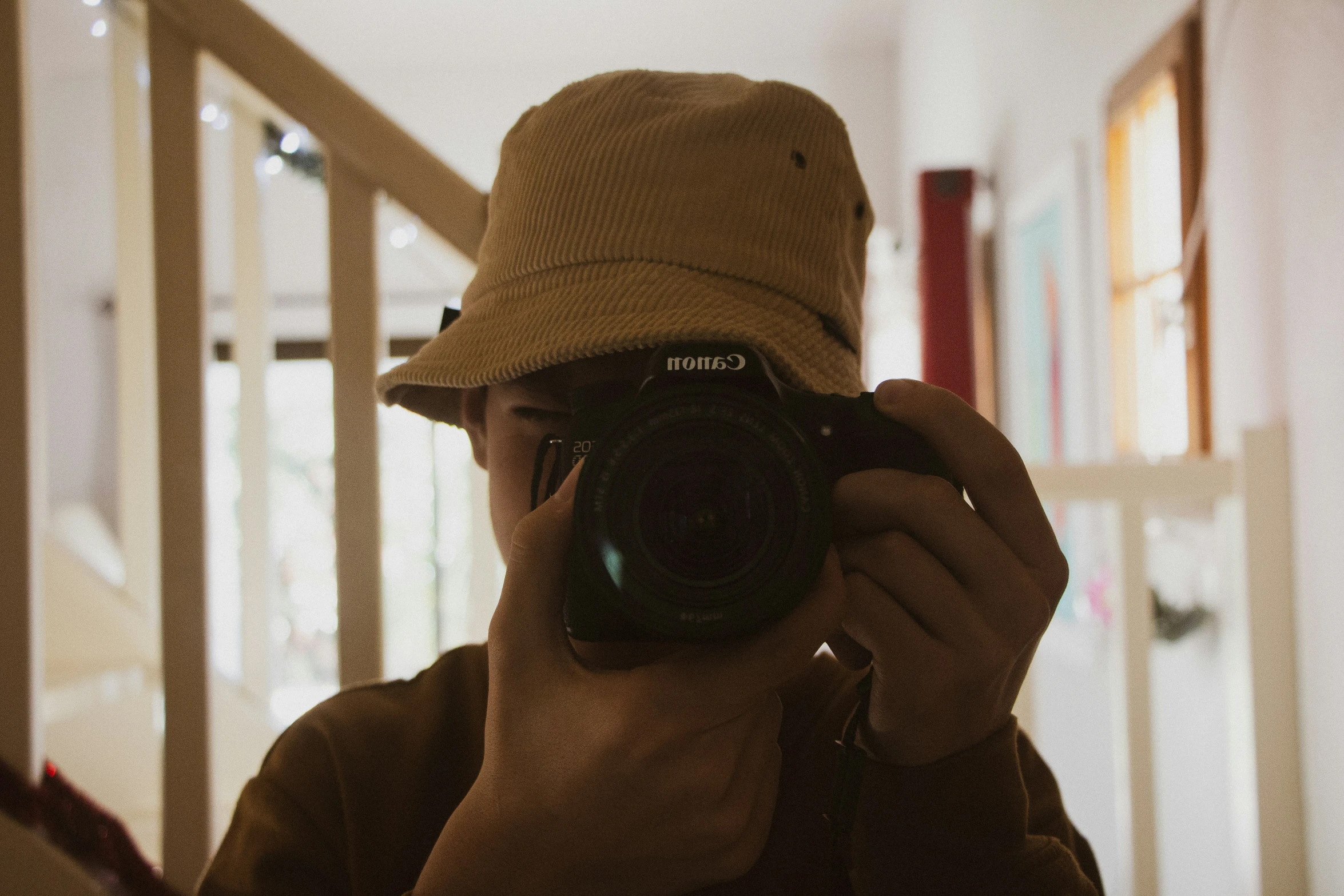 a man is taking a po of himself wearing a hat and taking a picture