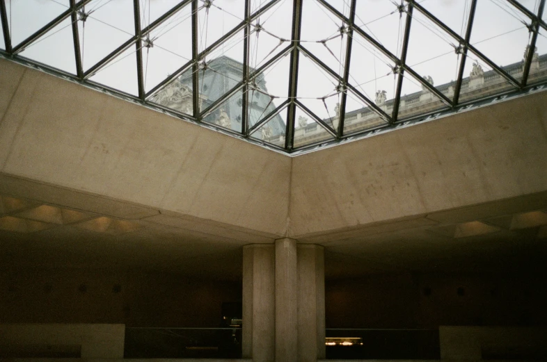 a concrete building with glass roof and skylights