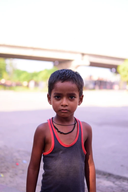 an image of a little boy standing in the street
