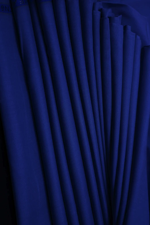 blue material on a surface next to a black background