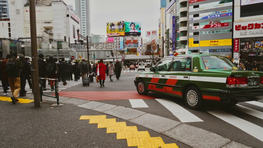 a car driving on the street in the middle of a city