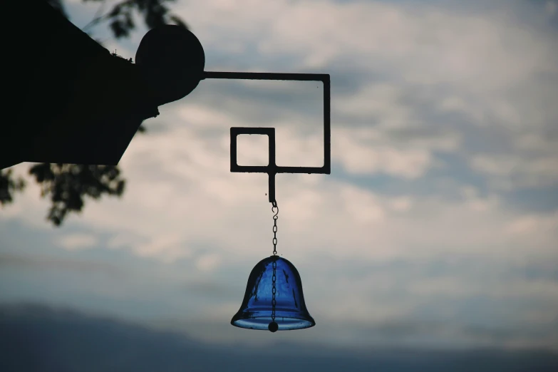 a metal object that has a hanging blue object on it