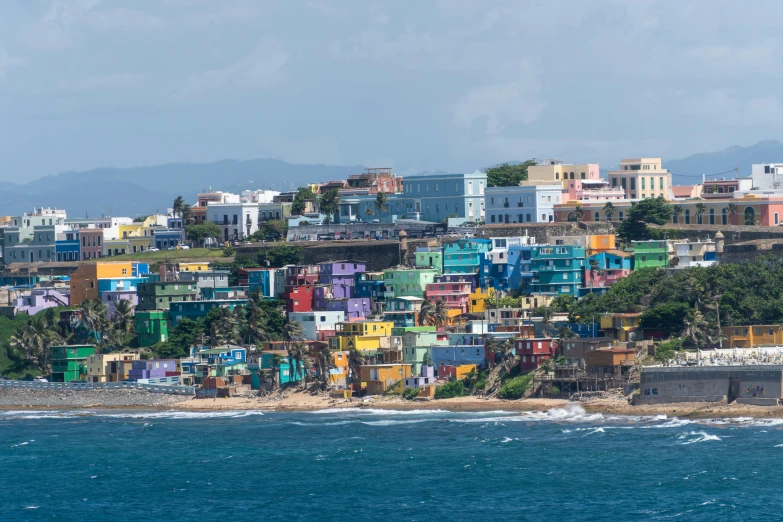 a view of a multi - colored coastal city next to the ocean