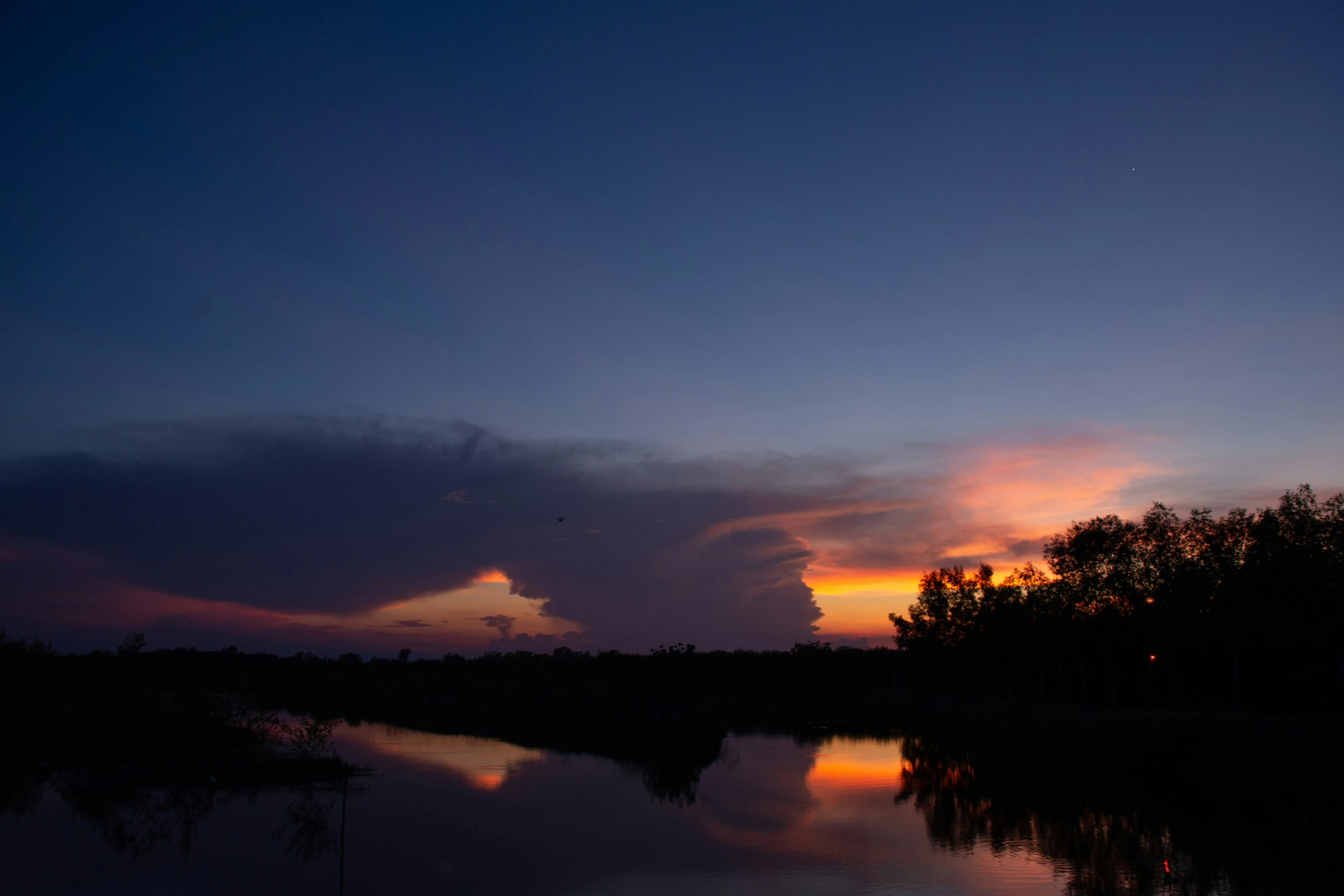 clouds at dusk over a lake during the day