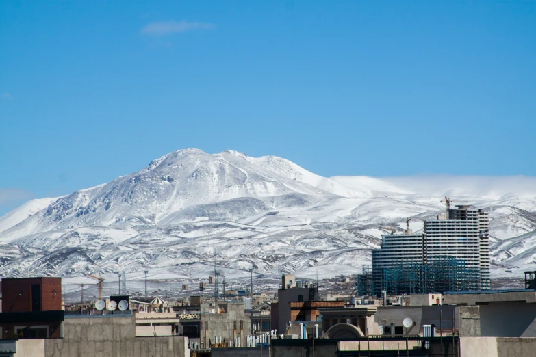 some buildings and some mountains with a lot of snow