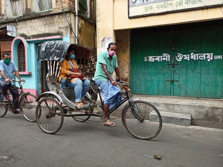 the three people are on their three wheeled bikes