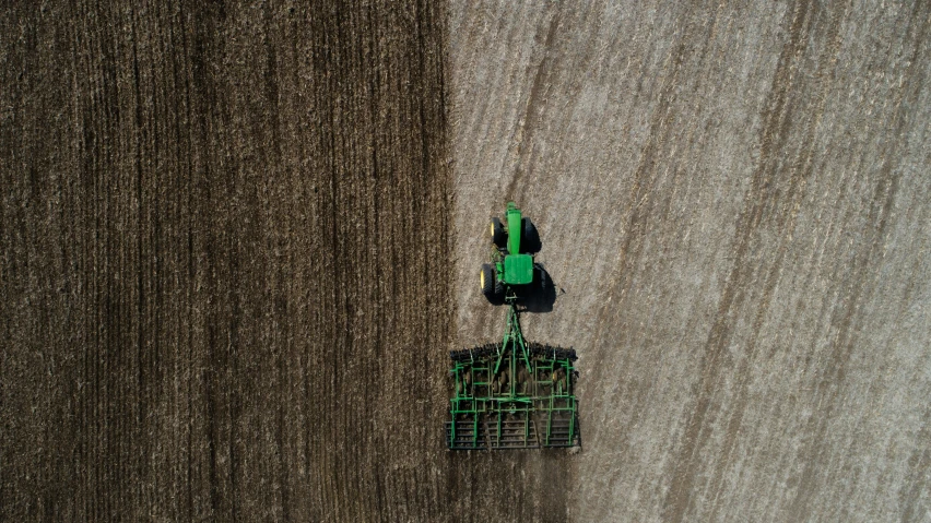 a seeder laying on the ground with seed in it