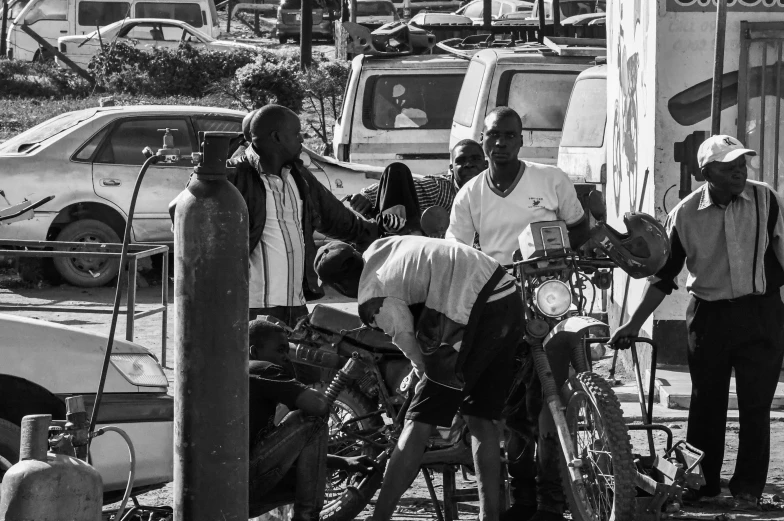 black and white image of men in street with bikes