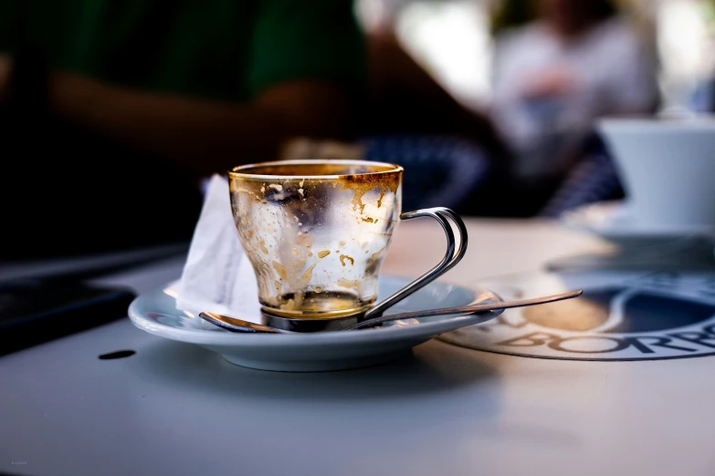 coffee cups sitting on saucers covered in rust