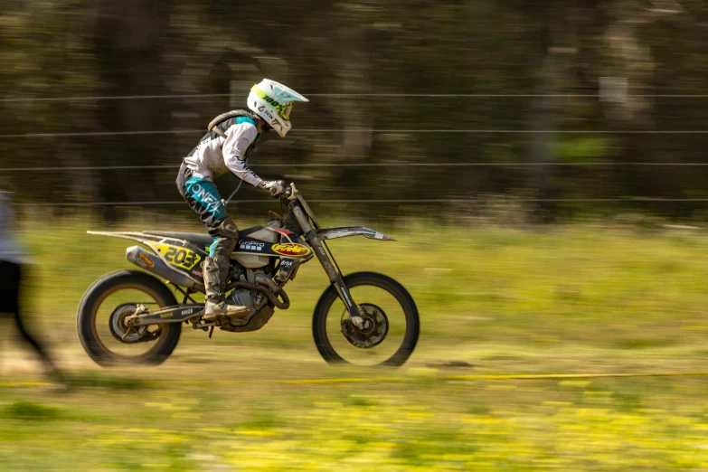 a person riding a dirt bike on a grass track