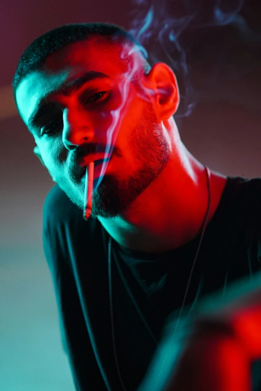 a man with earphones smoking a cigarette