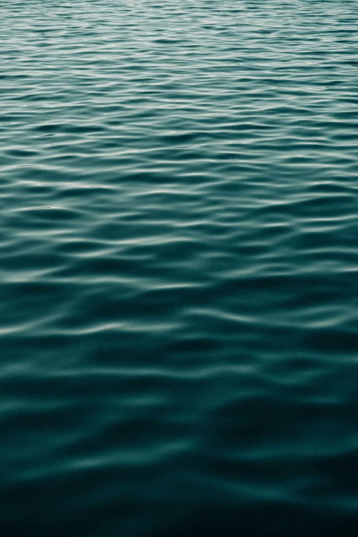 a boat floating in a body of water next to the ocean