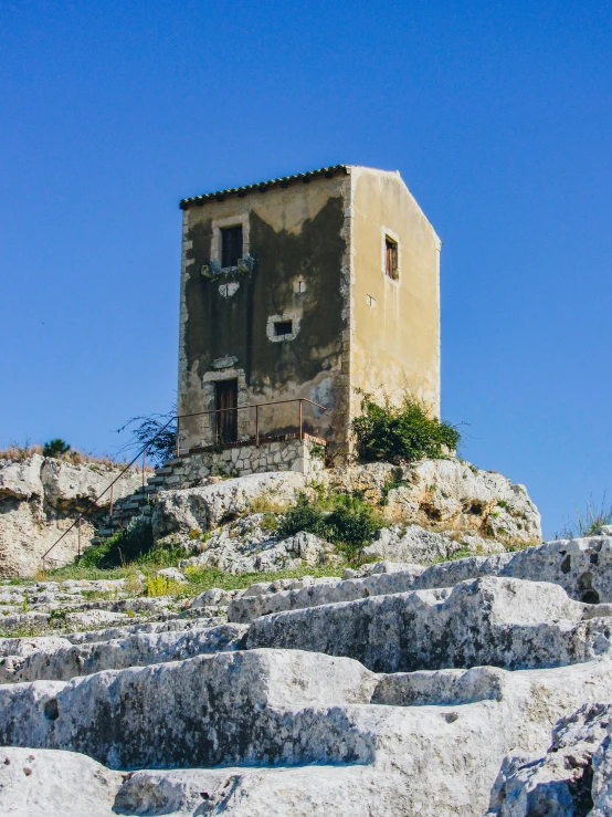 a large building sitting atop a rocky hillside