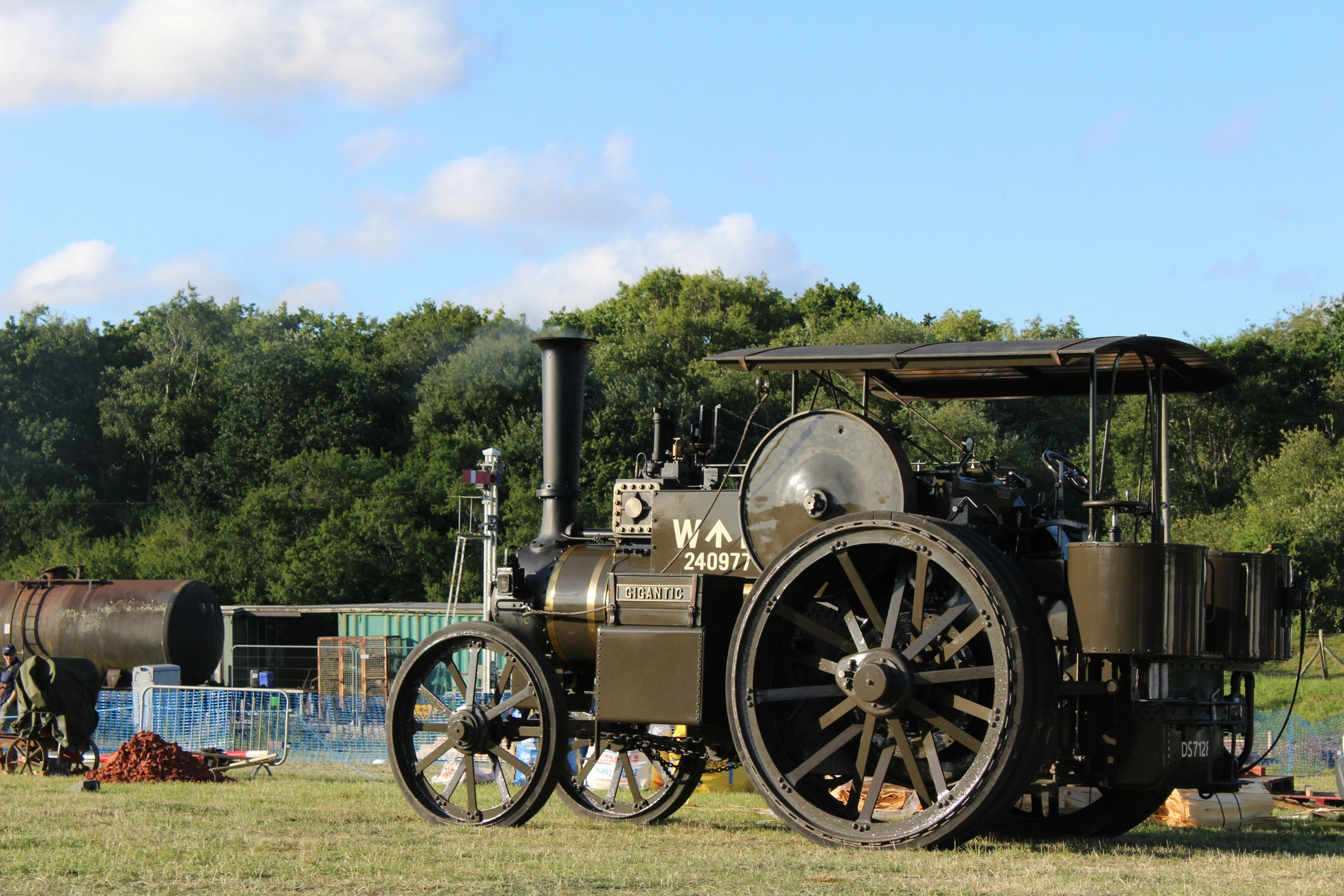 an antique locomotive engine and wagon sits on display