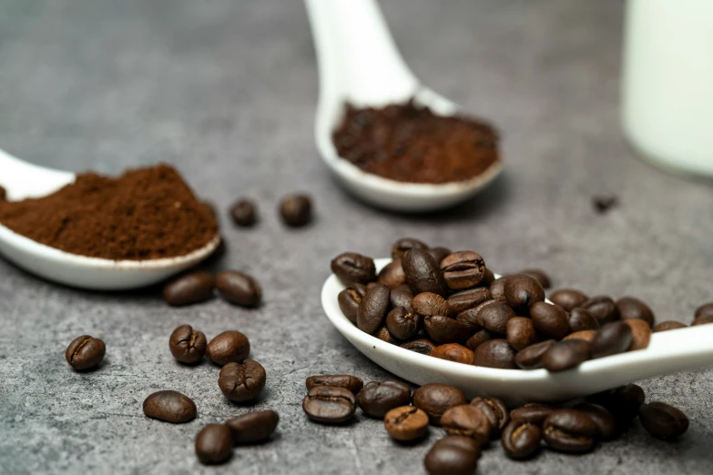 small bowls and spoons filled with coffee beans