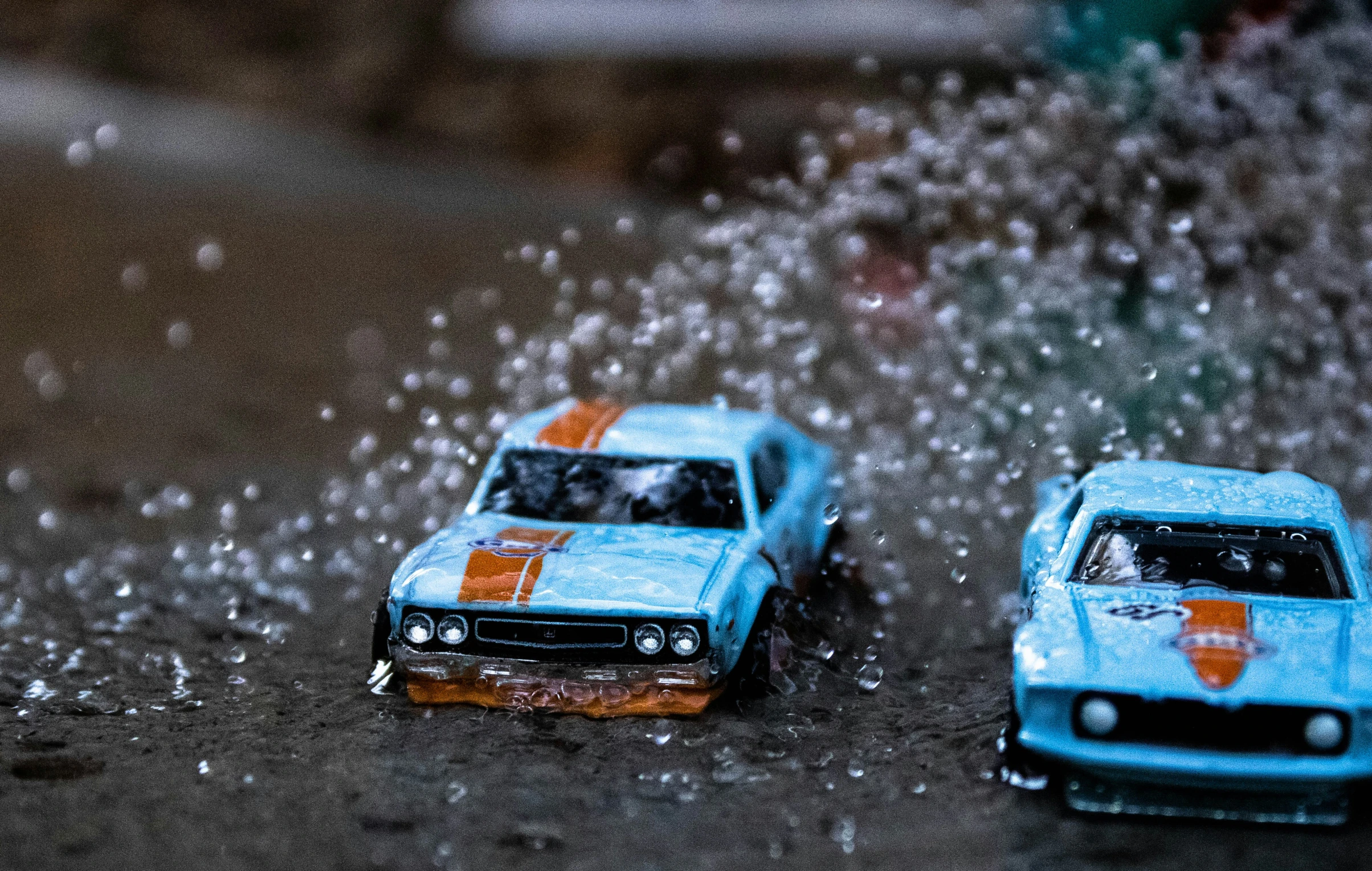 two toy cars in the rain on a rainy day