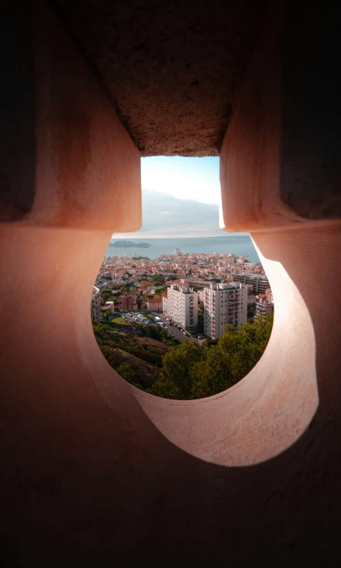 a window on a wall that looks out at a city