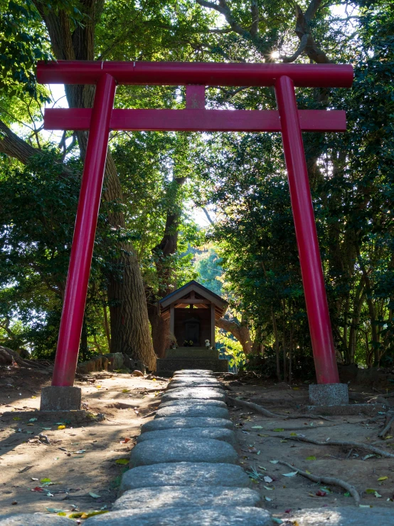 a red archway made out of sticks with rocks underneath