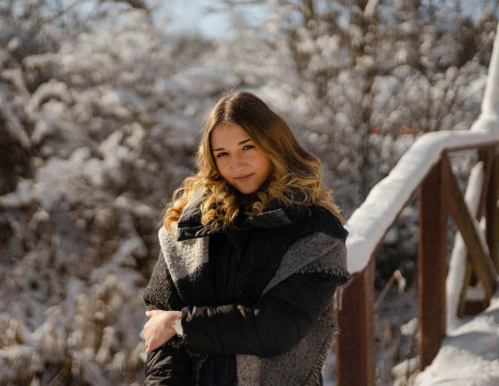 a woman in the snow in a park setting