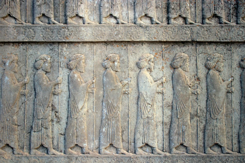 an intricately carved wall with carving of people