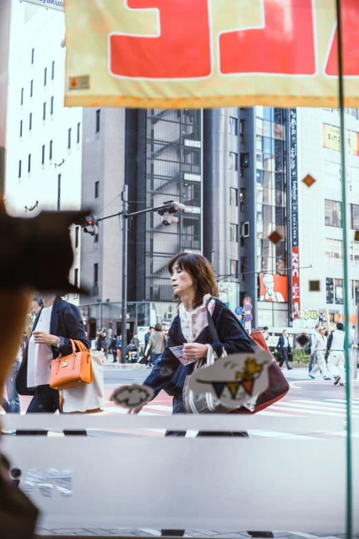 a woman sitting on the ledge in a city setting