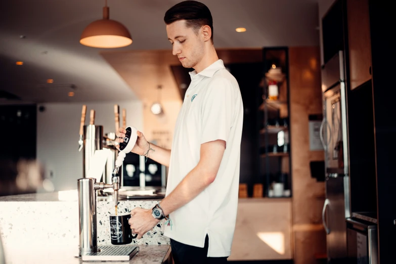 the man is at work using the coffee machine