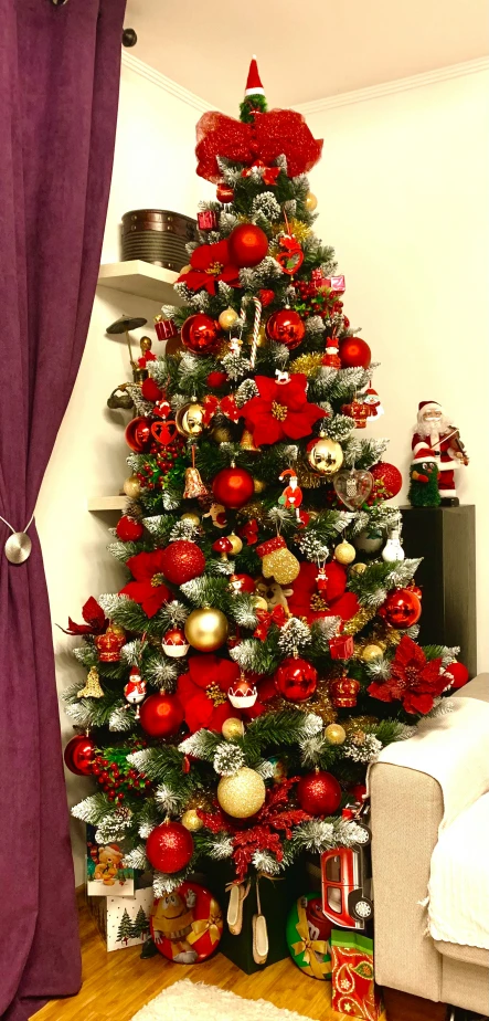 a christmas tree with lots of ornaments in a living room