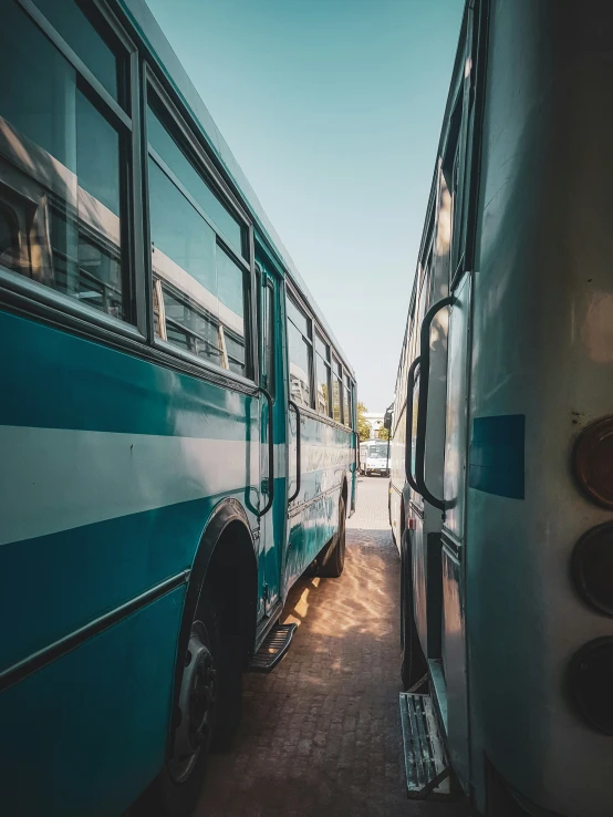 two large buses are next to each other