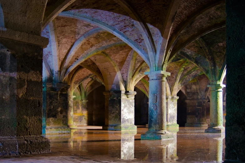 large hall with several arches and columns all around